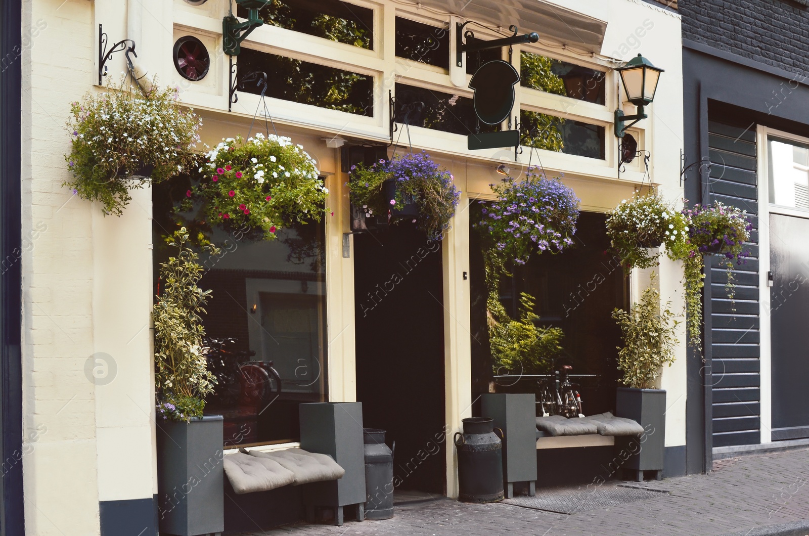 Photo of Beautiful facade of modern cafe with floral decor outdoors