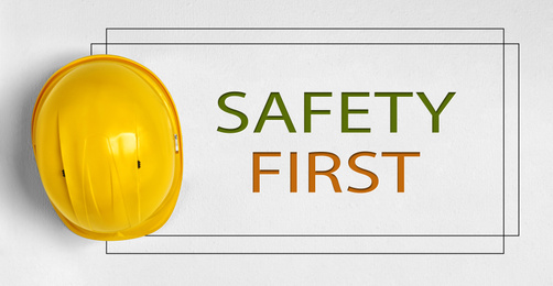 Image of Safety first. Hard hat on light background 
