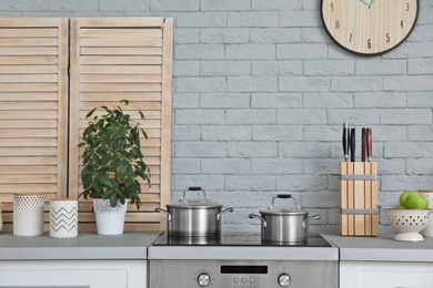 Photo of Modern kitchen interior with new furniture and different utensils