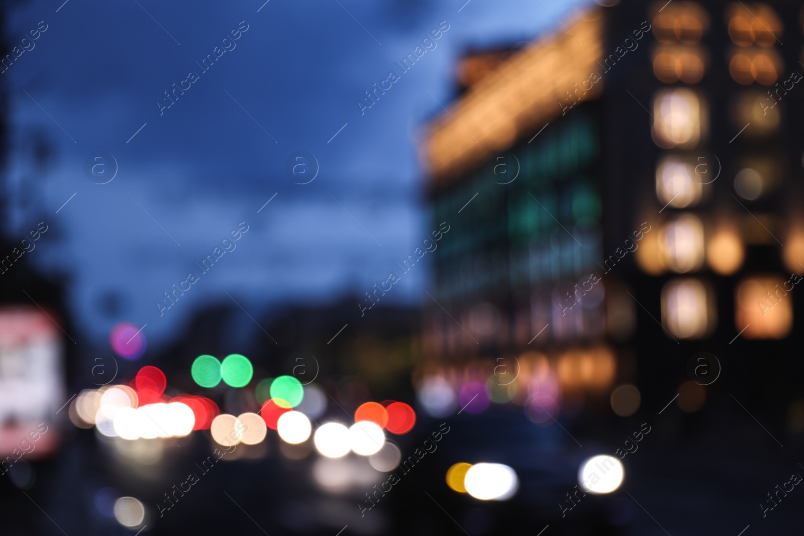 Photo of Blurred view of modern city at evening. Bokeh effect