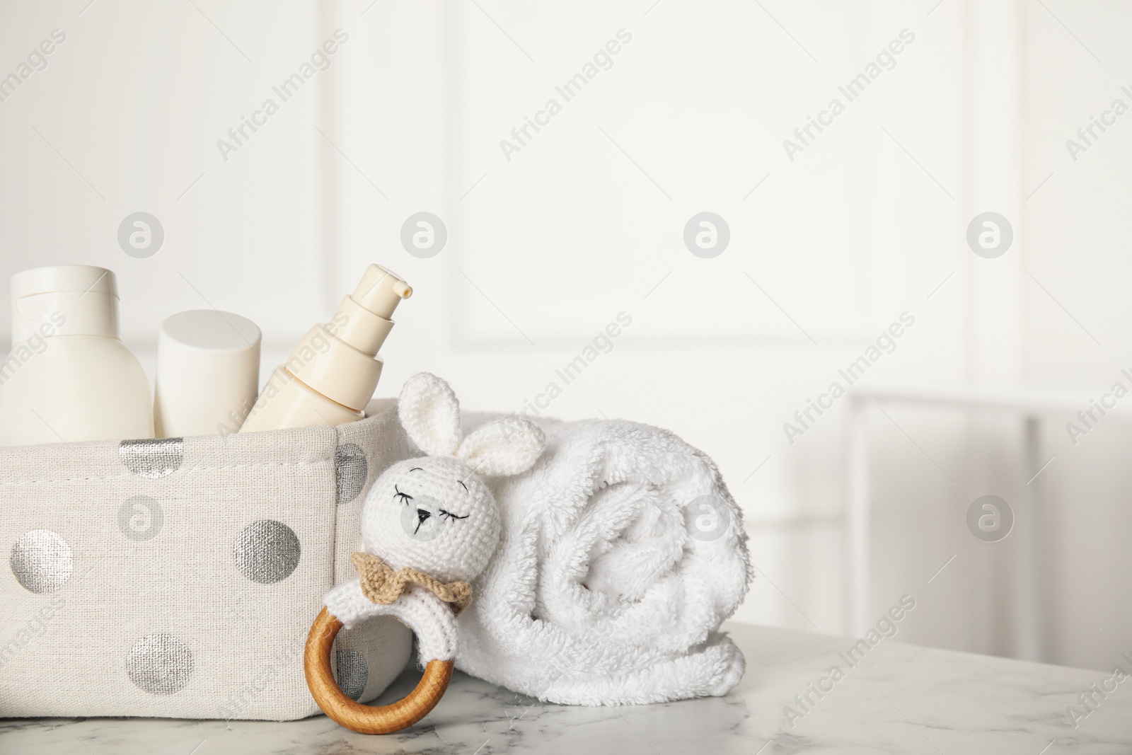 Photo of Baby accessories on white marble table indoors. Space for text