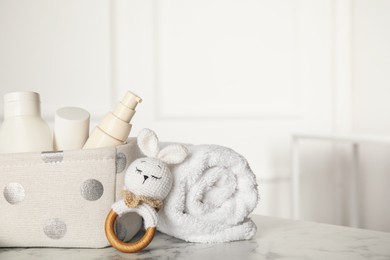 Baby accessories on white marble table indoors. Space for text