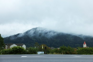 Photo of Beautiful view of asphalt road and conifer forest in mountains