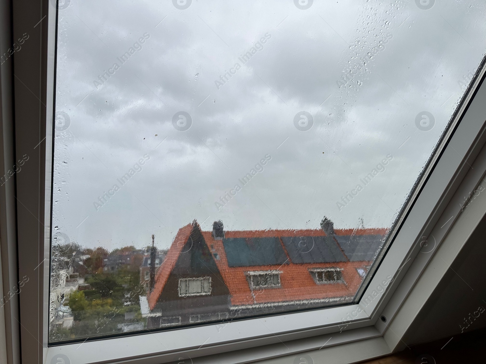 Photo of Window with water droplets on rainy day, closeup