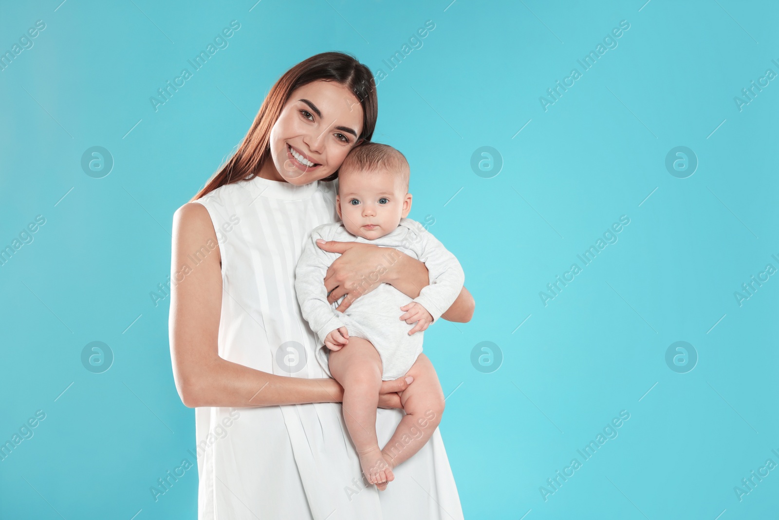 Photo of Portrait of happy mother with her baby on color background. Space for text