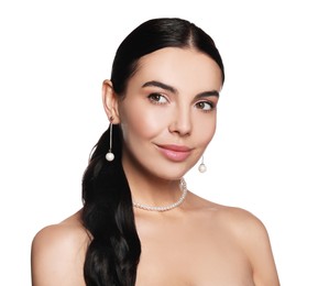 Photo of Young woman wearing elegant pearl jewelry on white background