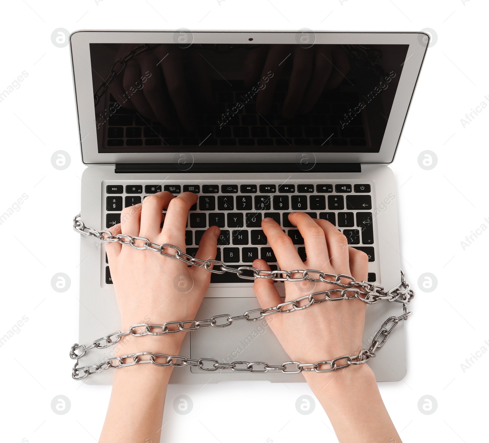 Photo of Woman with chained hands typing on laptop against white background, top view. Internet addiction