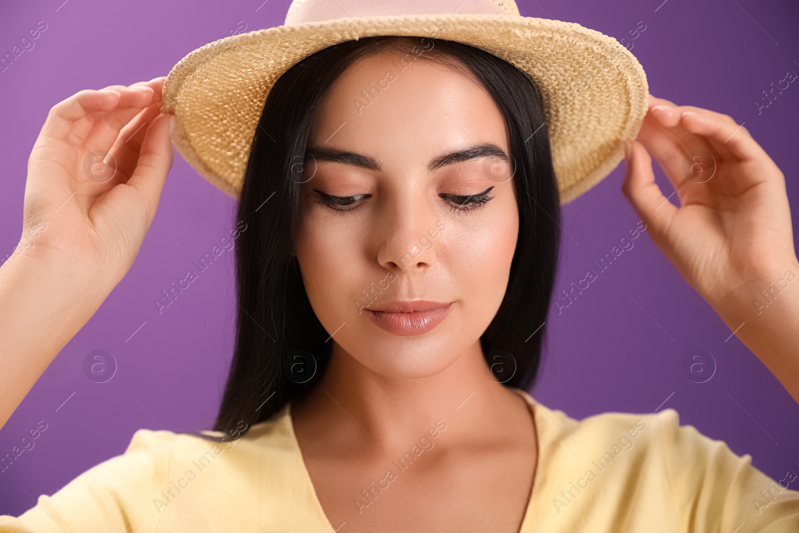 Photo of Portrait of beautiful young woman on purple background
