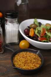 Photo of Tasty vinegar based sauce (Vinaigrette) on wooden table, closeup