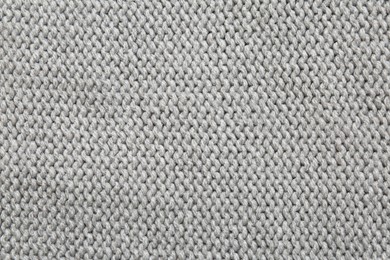 Photo of Beautiful grey knitted fabric as background, top view