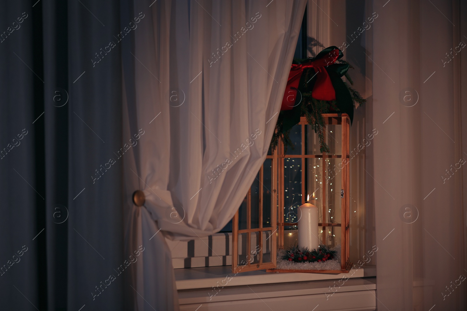 Photo of Beautiful Christmas lantern with candle on window sill indoors