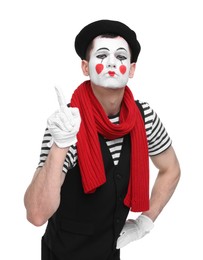 Photo of Funny mime artist gesturing on white background