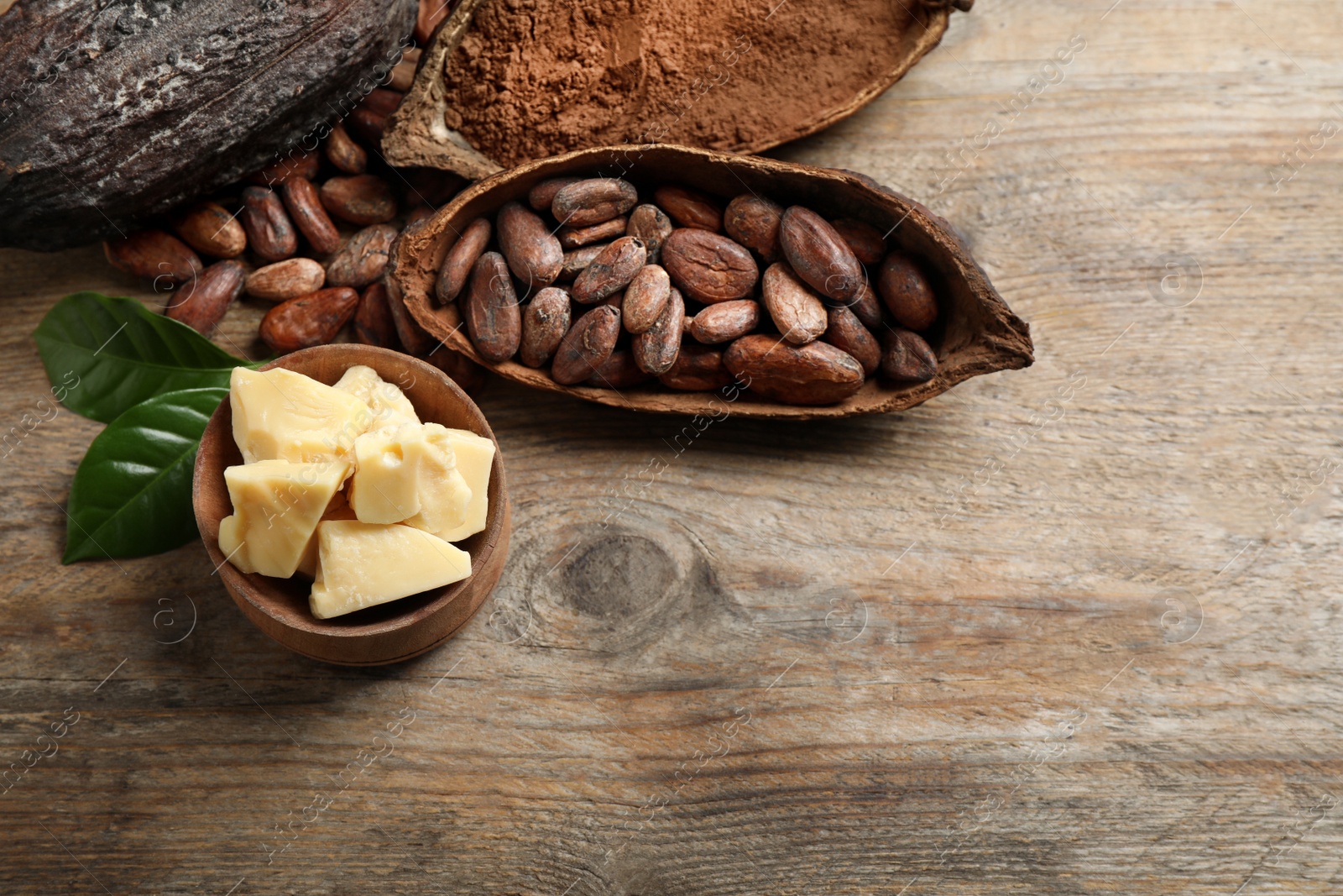 Photo of Flat lay composition with organic cocoa butter on wooden table. Space for text