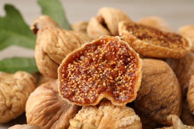 Pile of tasty dried figs on table, closeup