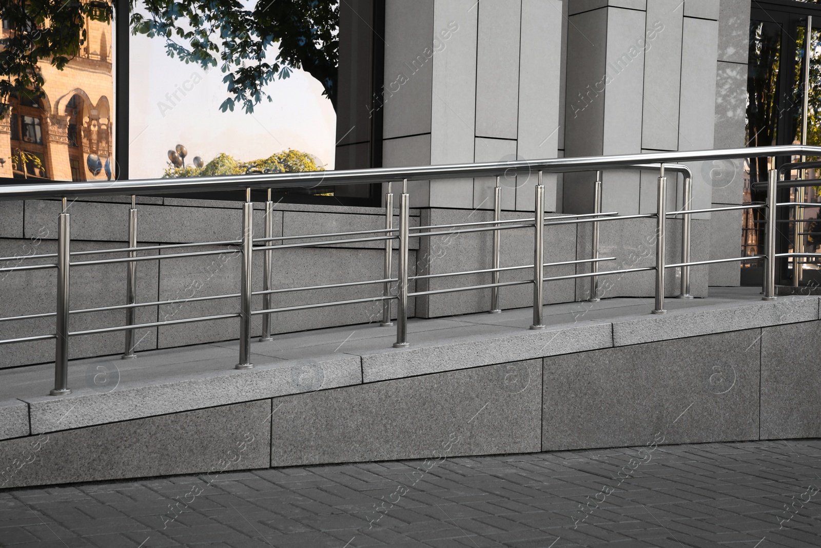 Photo of Ramp with metal handrails near building outdoors
