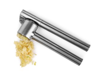 Photo of One metal press and crushed garlic isolated on white, top view