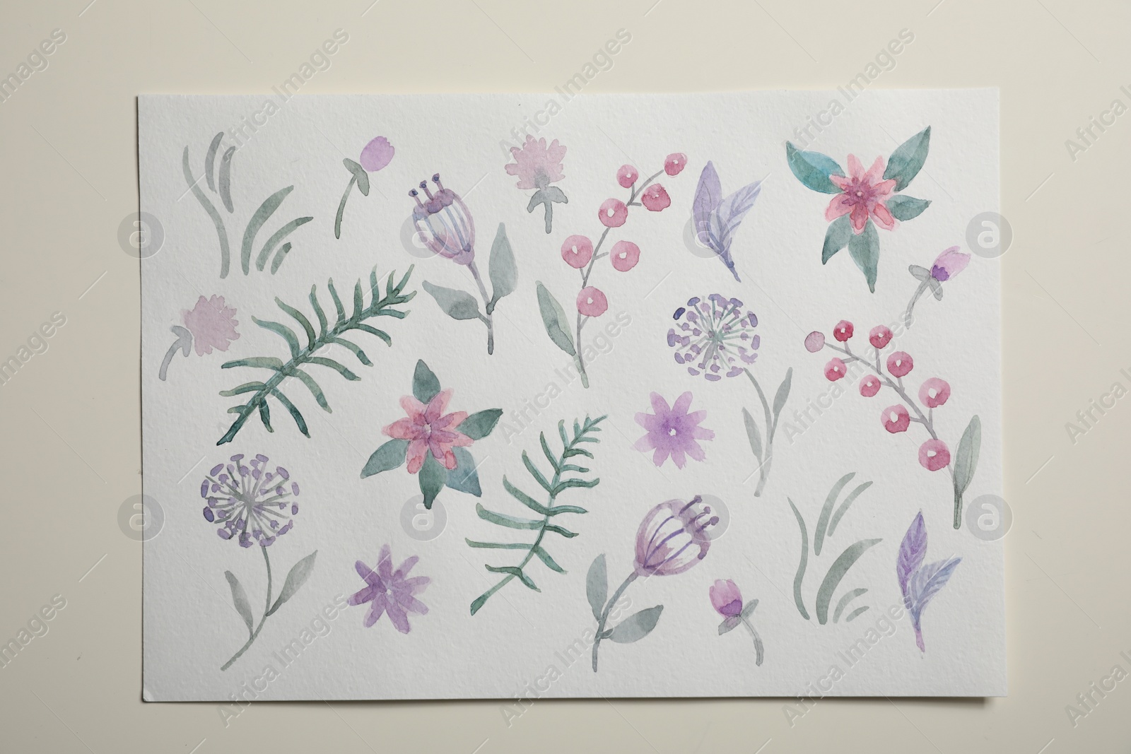 Photo of Sheet of paper with floral watercolor pattern on light background, top view