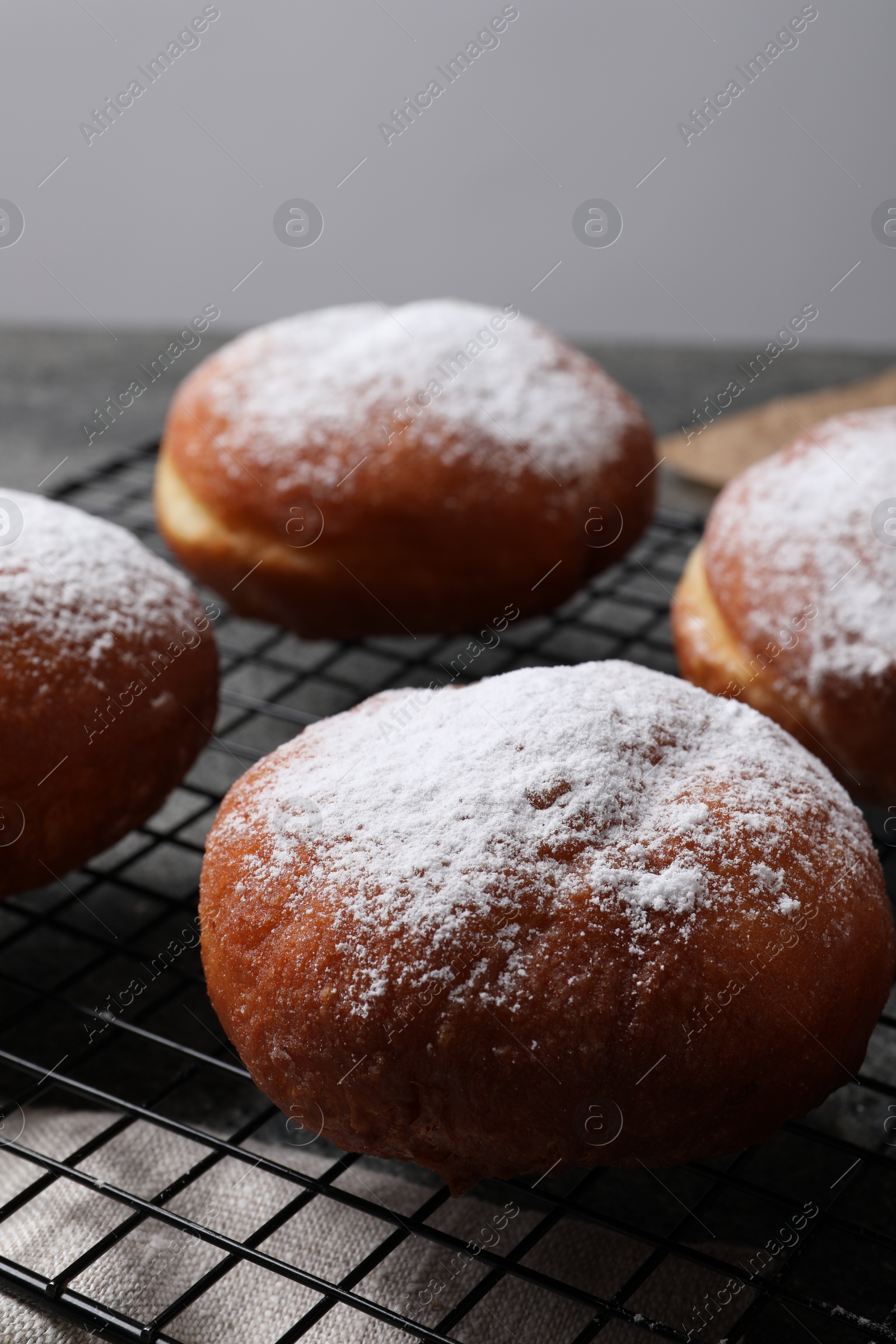 Photo of Delicious sweet buns with powdered sugar on table, closeup