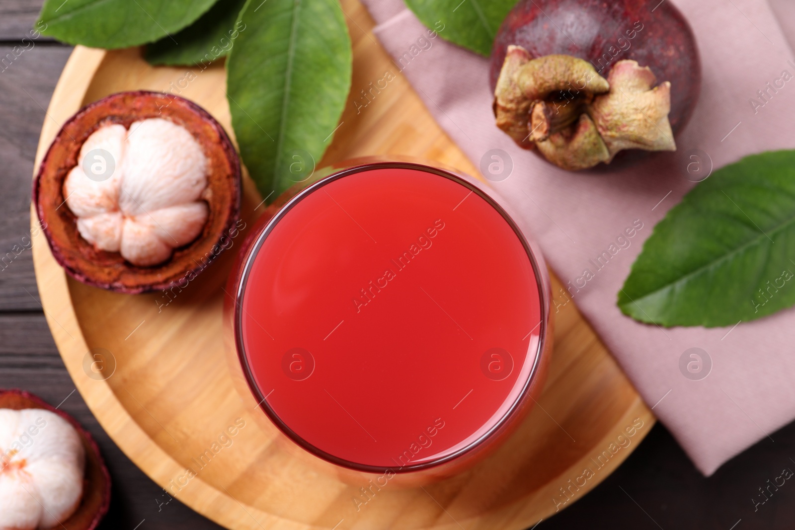 Photo of Delicious mangosteen juice and fresh fruits on table, flat lay