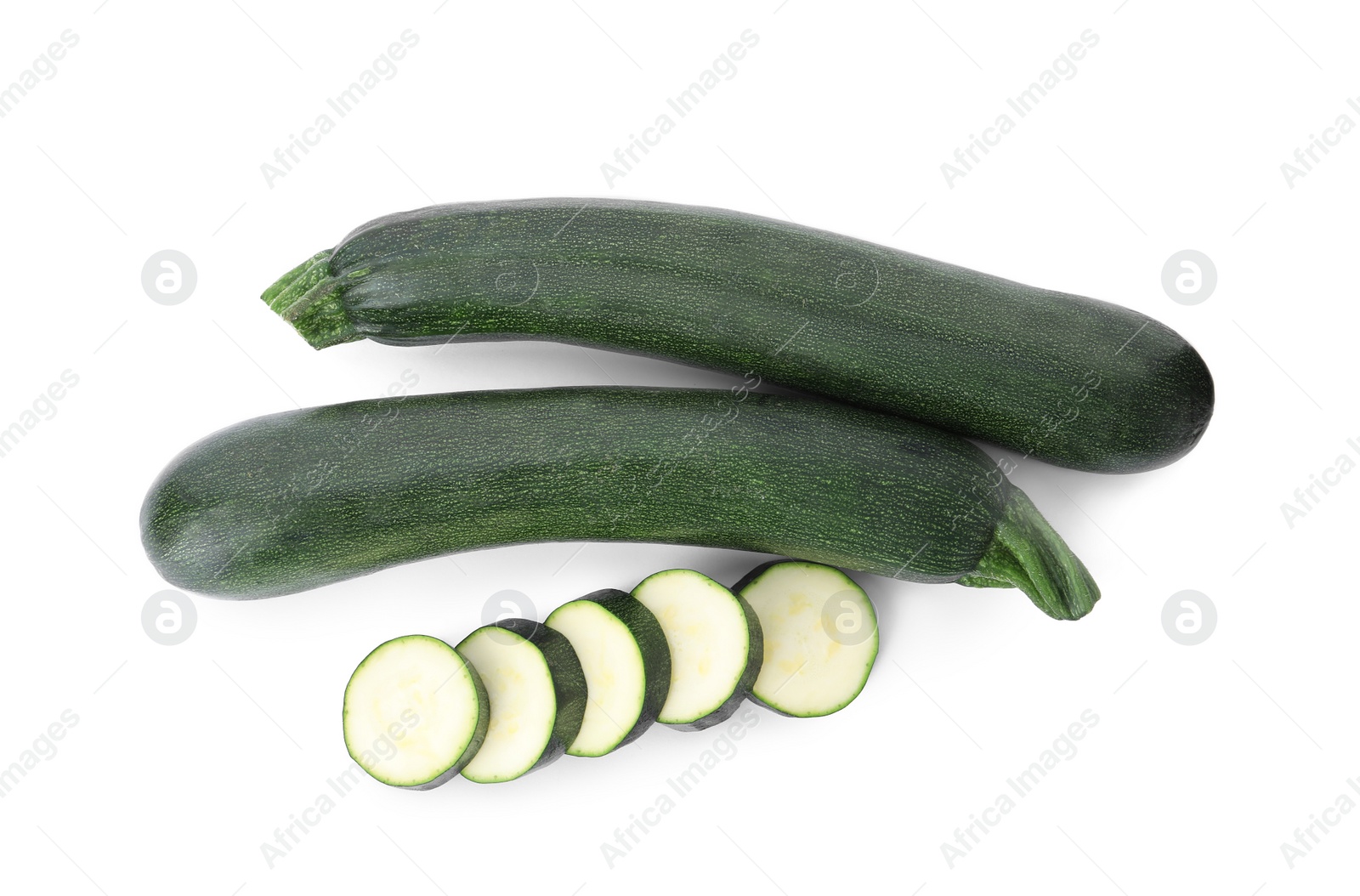 Photo of Cut and whole green ripe zucchini isolated on white, top view