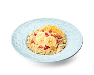 Plate of quinoa porridge with orange, banana and pomegranate seeds on white background