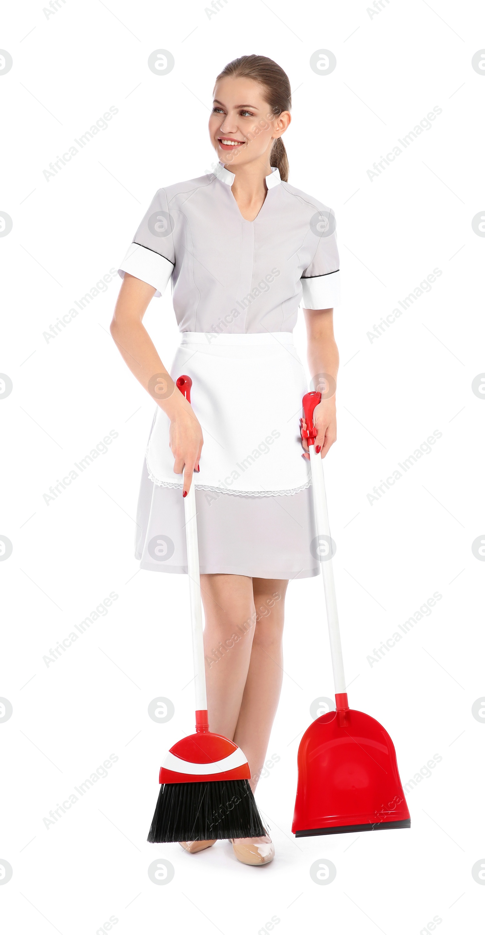 Photo of Young chambermaid with broom and dustpan on white background