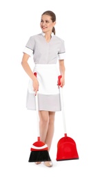 Young chambermaid with broom and dustpan on white background