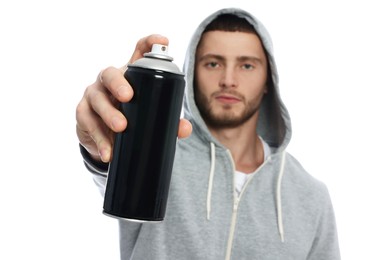 Photo of Handsome man holding can of black spray paint against white background