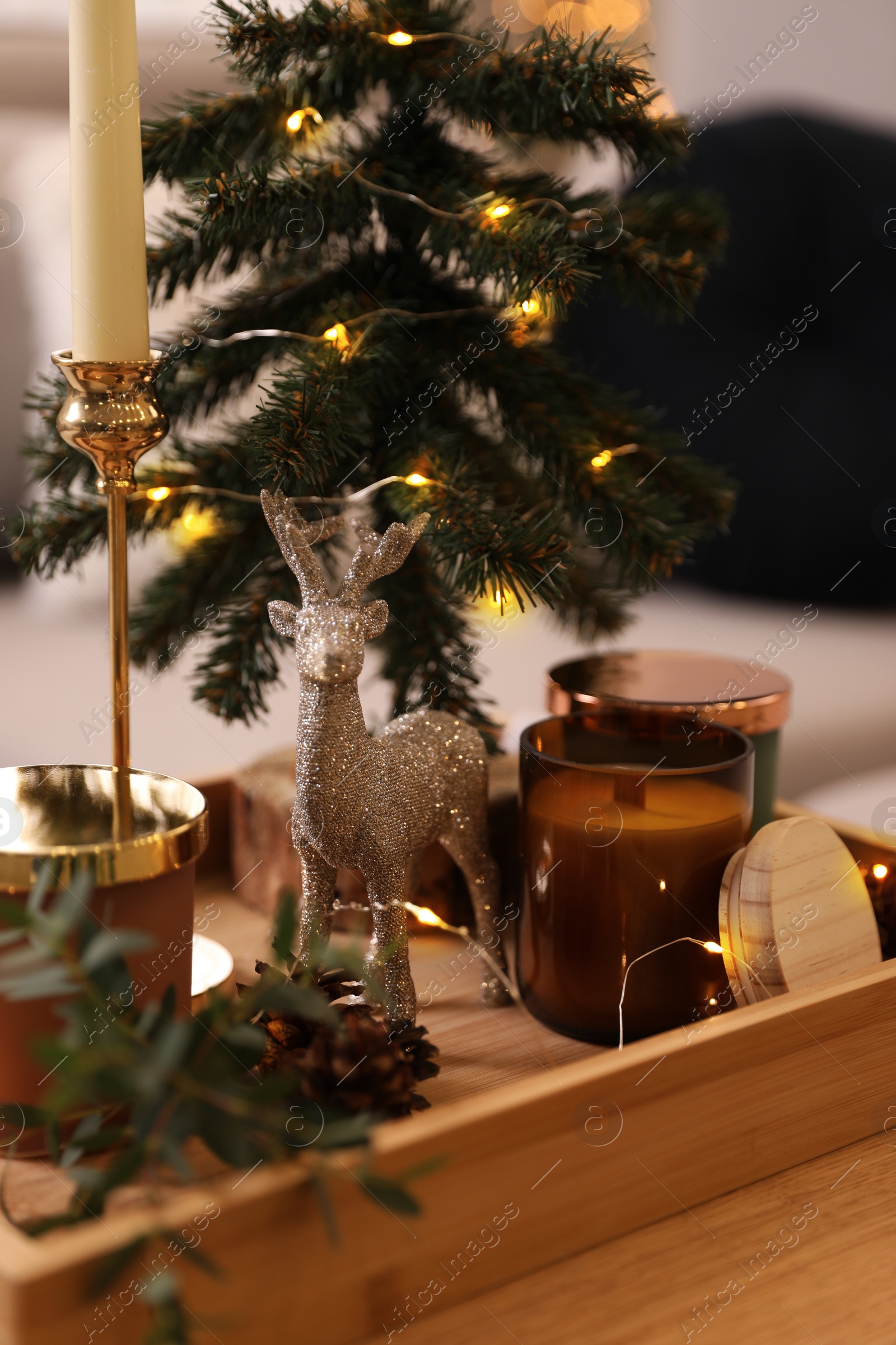 Photo of Composition with decorative Christmas tree and reindeer on wooden tray, closeup