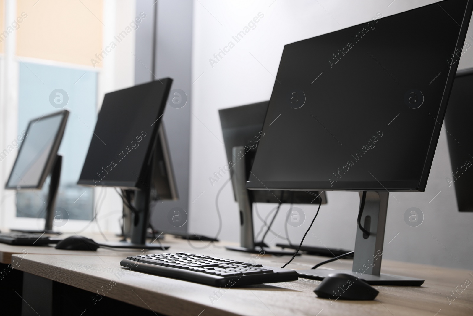 Photo of Many modern computers in open space office