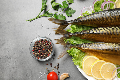 Photo of Flat lay composition with tasty smoked fish on grey table