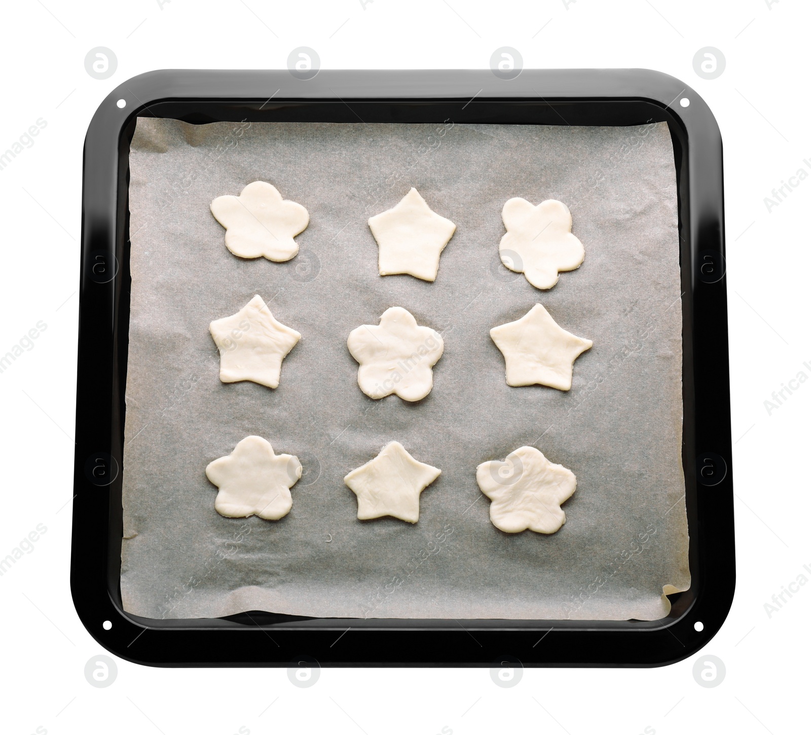 Photo of Baking pan with unbaked cookies and parchment paper isolated on white, top view