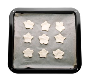 Photo of Baking pan with unbaked cookies and parchment paper isolated on white, top view