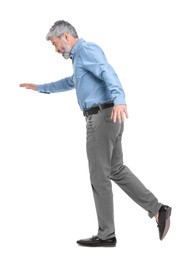 Photo of Mature businessman in stylish clothes posing on white background