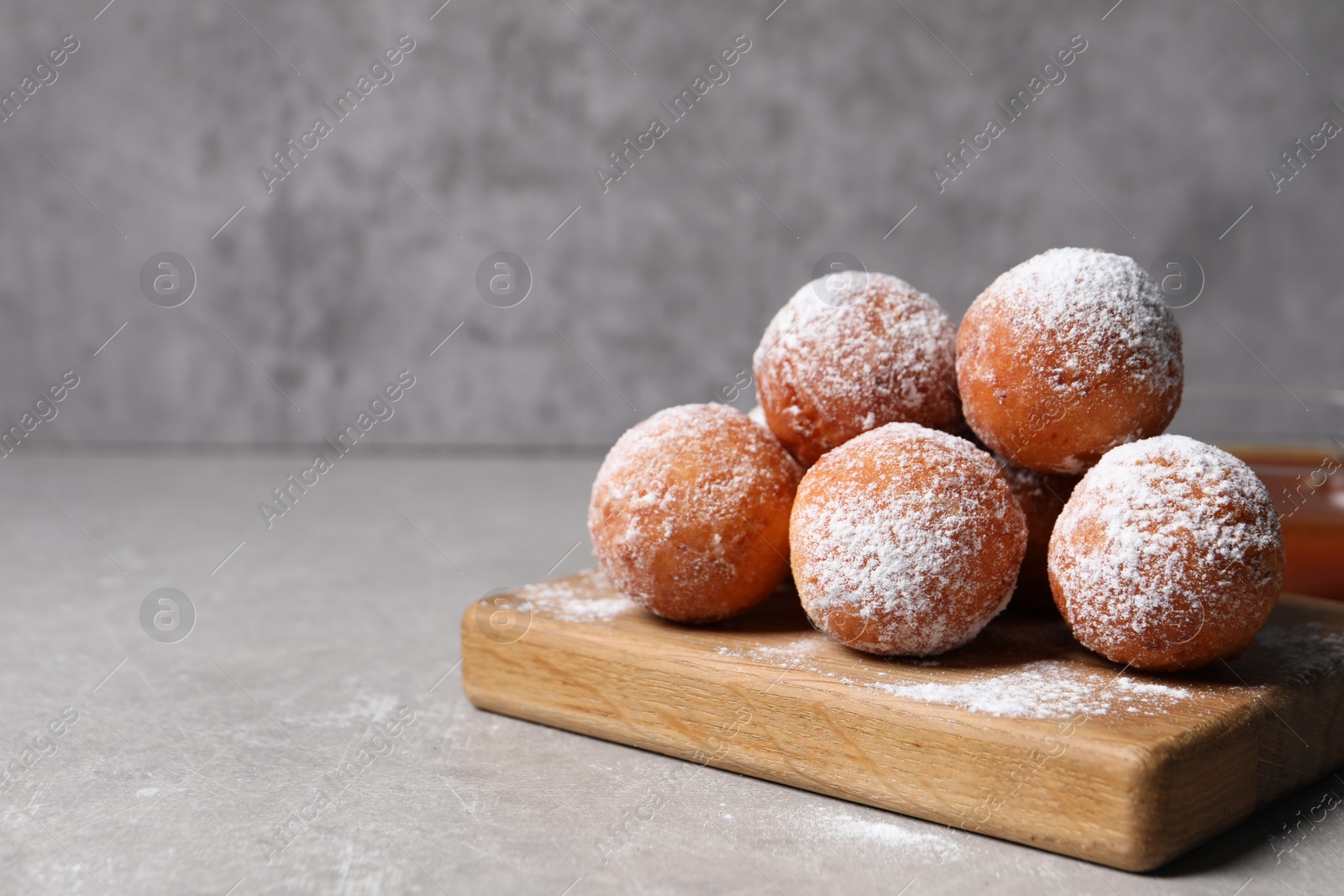 Photo of Delicious sweet buns on gray table, space for text