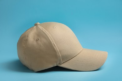 Photo of Baseball cap on light blue background. Mock up for design