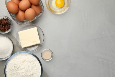 Photo of Flat lay composition with flour, butter and different ingredients on light grey table, space for text. Cooking yeast cake