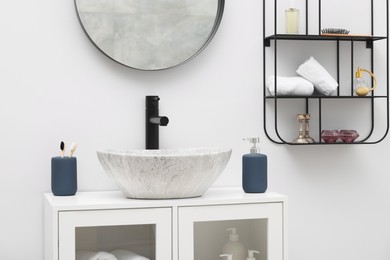 Photo of Different bath accessories, personal care products and bathroom vanity indoors