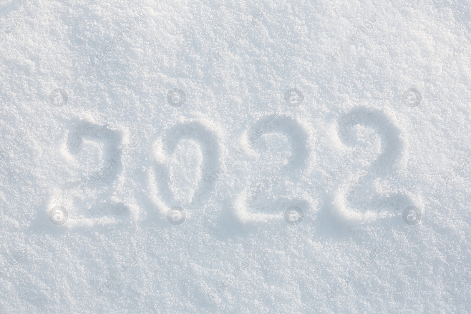 Photo of 2022 written on white snow, top view