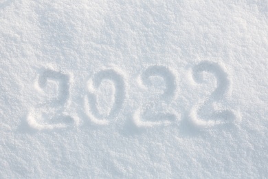 Photo of 2022 written on white snow, top view