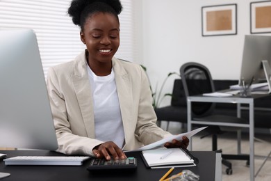 Professional accountant working at desk in office. Space for text