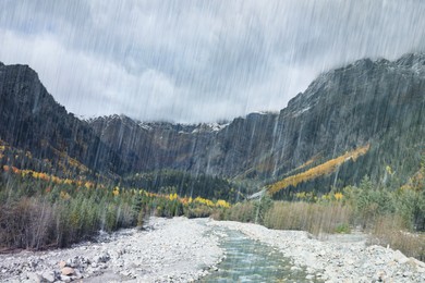 Image of Picturesque view of river in mountains with forest on rainy day