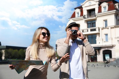 Photo of Couple of tourists taking picture on beautiful city street