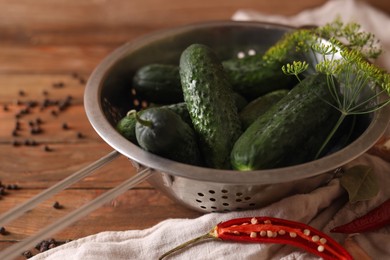 Photo of Fresh cucumbers, dill, garlic and pepper on wooden table, closeup. Pickling recipe