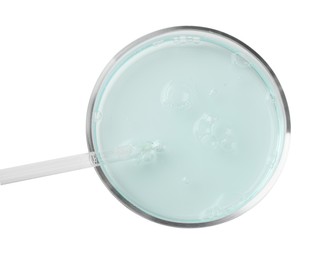 Petri dish with light blue liquid sample and pipette on white background, top view