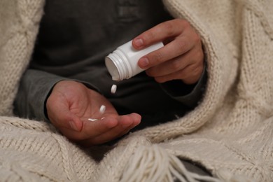 Man pouring antidepressants from bottle, closeup view