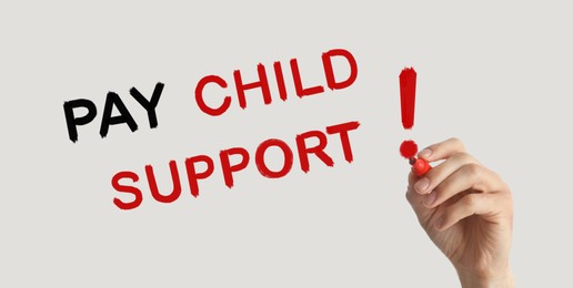 Image of Woman with marker and phrase PAY CHILD SUPPORT! on beige background, closeup. Banner design