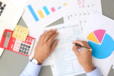 Tax accountant working with documents at table