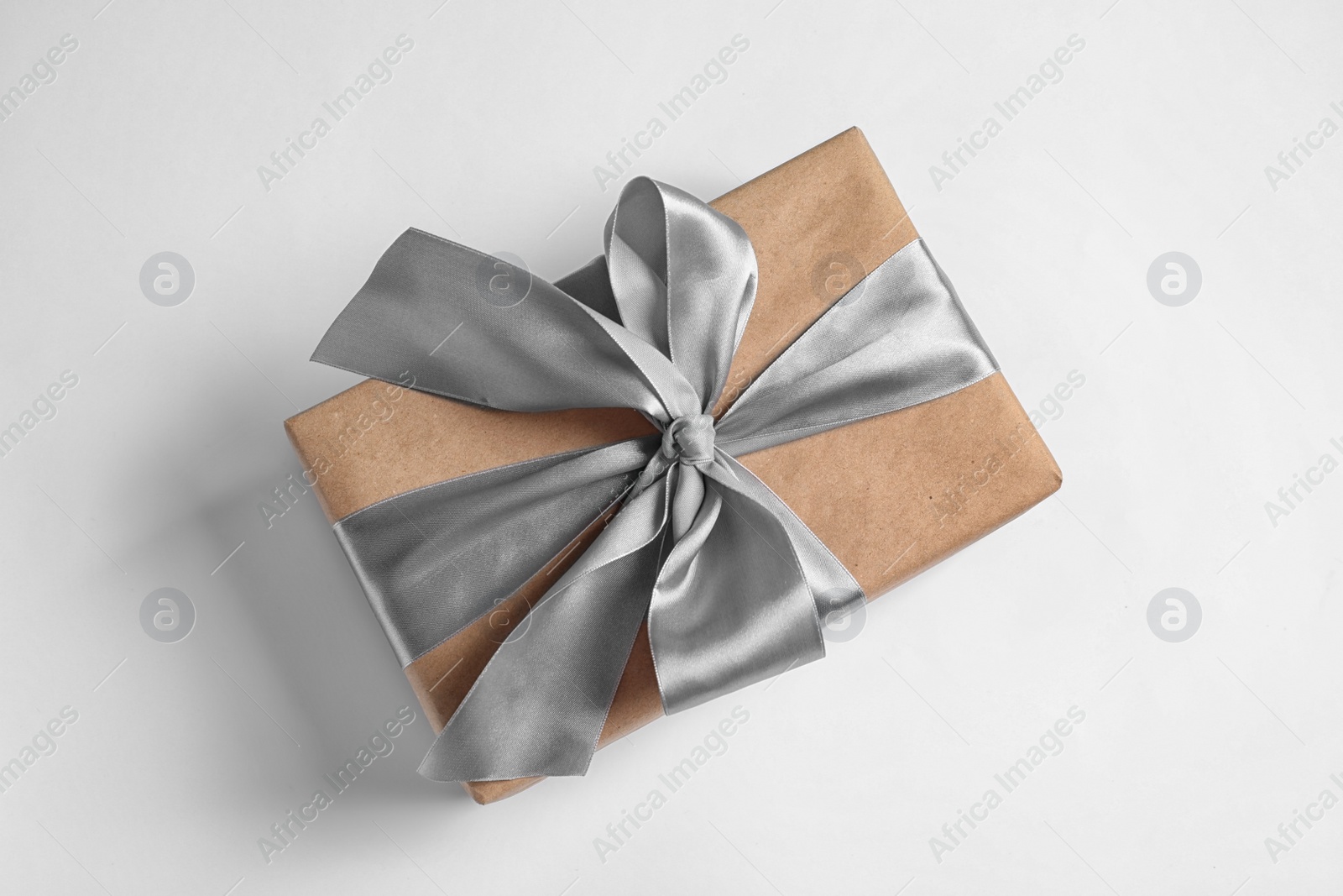 Photo of Beautifully wrapped gift box on white background, top view