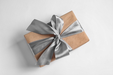 Photo of Beautifully wrapped gift box on white background, top view